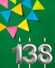 Vertical birthday card with number 138 candle - Green background with pennants