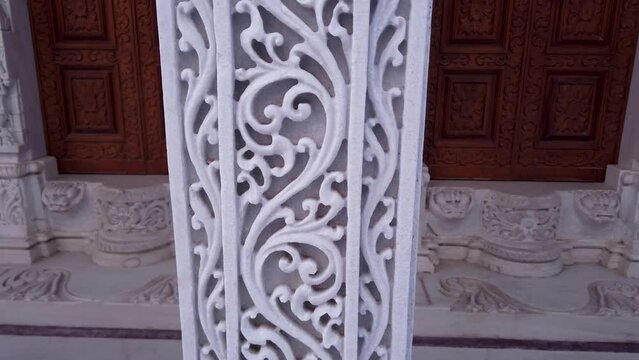 Udaipur, Rajasthan, India-October 30 2023; A Close up view of Intricately carved designed patterns on a White marble pillar at a Jain temple dedicated to Lord Mahavira at Udaipur in Rajasthan, India.
