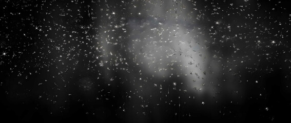 Abstract real dust floating over black background.Dust paricles for overlay use in vintage or...