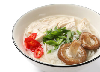 Delicious ramen with meat and mushrooms in bowl isolated on white. Noodle soup