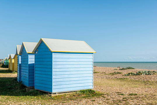 Colorful huts at the beach, East Sussex, England.