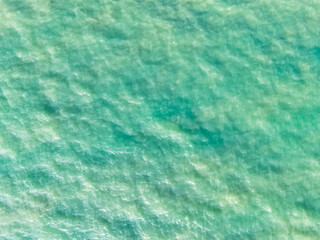 Sea aerial view. Top view of the sea water with the waves of the crashing onto the shore. High angle photo, background water sea natural view, for use as a background for relaxation, travel