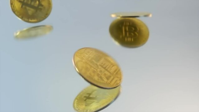 Close-up, gold Bitcoin physical coins falls on glass white table, scattering over the surface. Copy space. BTC Bit- coin, B-roll.