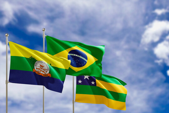 Official flags of the country Brazil, state of Sergipe and city of Nossa Senhora do Socorro. Swaying in the wind under the blue sky. 3d rendering