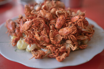 River crab crispy dish on red table.