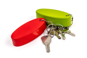 Red and green key ring floats, colored like marrtime buoys, isolated on white