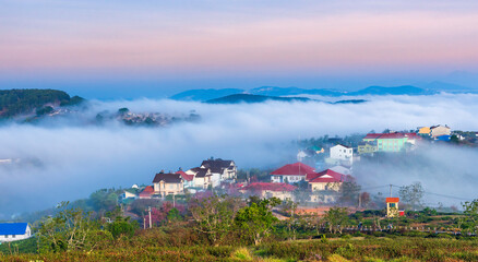 The morning landscape in the valley Da Lat, Vietnam with fog covered and sunrise background is so...