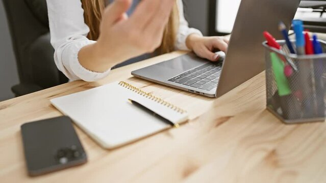 Young, blonde office worker cheerfully offers a friendly palm; giving assistance and acceptance in the business world
