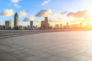 Empty square floor and city skyline with modern buildings scenery at sunset in Shanghai. Famous Bund landmark in Shanghai.