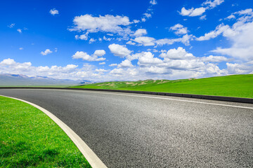 Asphalt road and green mountain nature landscape under blue sky