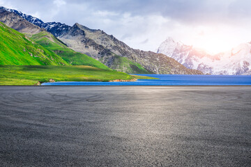 Asphalt road square and blue lake with mountain natural landscape in summer