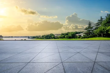 Foto op Aluminium Empty square floor and green forest with buildings landscape at sunset © ABCDstock