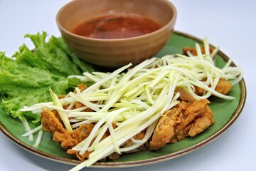 crispy chicken with mango sauce or Ayam Saus Mangga. The taste is savory spicy and a little sweet. Selective Focus
