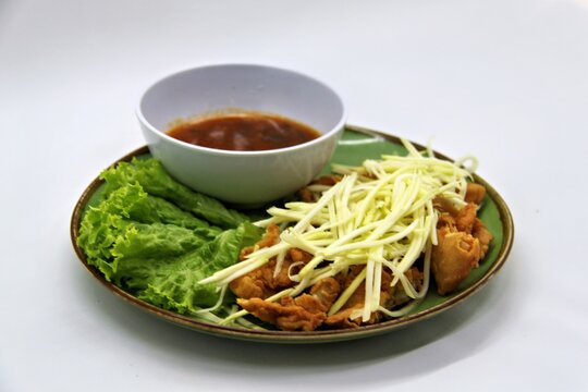crispy chicken with mango sauce or Ayam Saus Mangga. The taste is savory spicy and a little sweet. Selective Focus