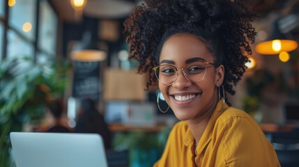 Obraz premium Smiling businesswoman and coworker working over laptop at creative office