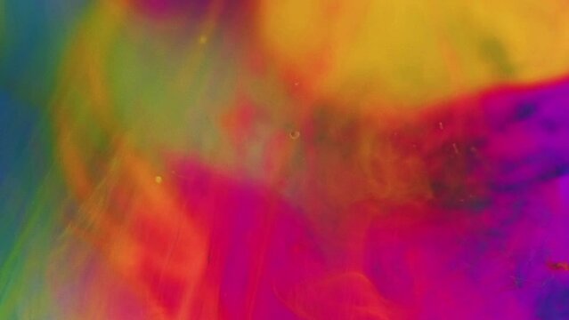 Color ink water. Oil bubble. Defocused neon magenta pink blue yellow paint mix mist texture transparent fluid drop art abstract background.