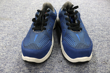 Photo of blue sports shoes or sneakers, usually for jogging or other sports in the morning