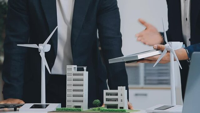 Diverse group of business people planning for alternative energy utilization for greener sustainable Earth by reducing CO2 emission and carbon credit with renewable clean energy technology. Quaint