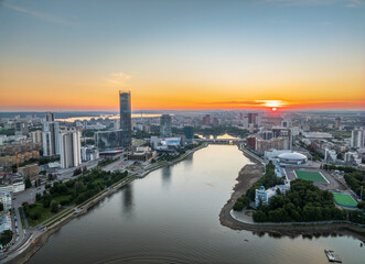 Fototapeta premium Yekaterinburg city and pond aerial panoramic view at summer sunset.