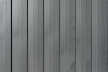 Texture of black metal standing seam facade. Minimalist building exterior design. Metal wall rebated panels as background - obrazy, fototapety, plakaty