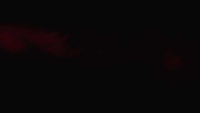 Close-up of Particles in Red Light Beam