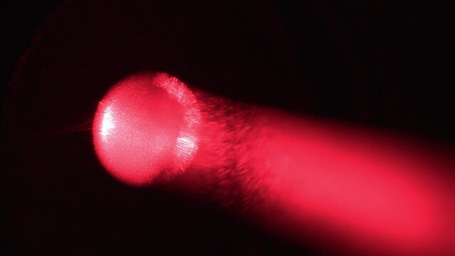 Close-Up of Laser Pointer Shooting Red Light Particles Beam