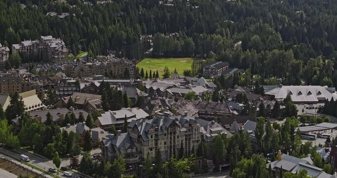 Whistler BC Canada Aerial v12 zoomed drone flyover resort town center, panning views of thrilling mountain bike park course, uphill lifts surrounded by forests - Shot with Mavic 3 Pro Cine - July 2023