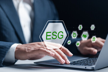 ESG environmental, social and governance concept. social business strategy, environment, business investment strategy, world sustainable environment. Businessman using laptop with ESG icons.