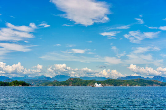 Ferry boat and scenic coastal mountains in a view from Quadra Island, BC, Canada 