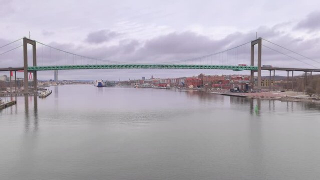 Wide aerial tracking shot of &Auml;lvsborg bridge spanning G&ouml;ta &Auml;lv river, Gothenburg