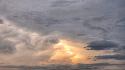 a stormy sky with clouds and sun shining through