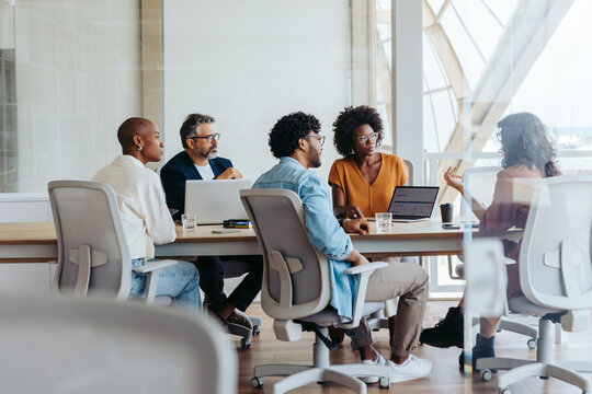 Creative business meeting of professionals brainstorming ideas in a collaborative boardroom