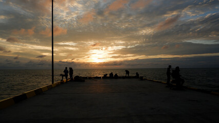 Natural Scenery In The Afternoon Above The Tanjung Ular Sea Pier, With Several Silhouettes Of...