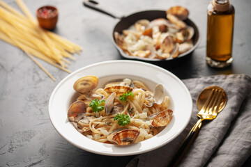 Seafood pasta with clams. Spaghetti alle Vongole on a light background.