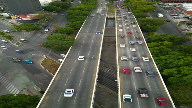 Vertical drone footage from a near-cenital perspective overlooking the bustling traffic on Guadalajara's Matute Remus Bridge