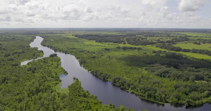 Aerial view of large river in Florida farmland that connects to Lake Okeechobee
