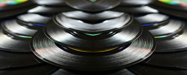a black background of old vinyl records with reflections of jazz music
