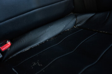 Damaged, worn, dusty, cracked leather car seat. Repair concept, sewing new car seat upholstery.