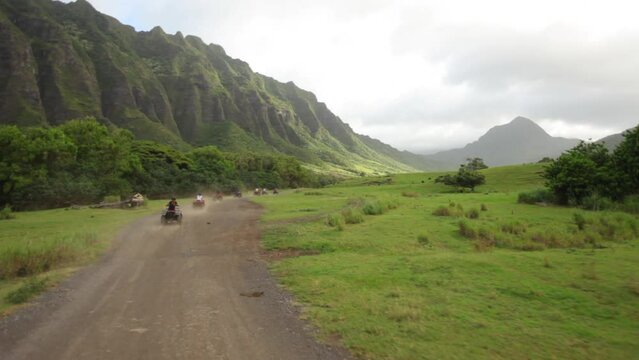 Majestic Hawaiian valley and four-wheelers - steady cam shot