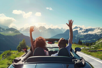 happy woman and man driving a convertible, raising their hands to the sky, against the backdrop of snowy mountains on a sunny summer day. Travel, vacation concept