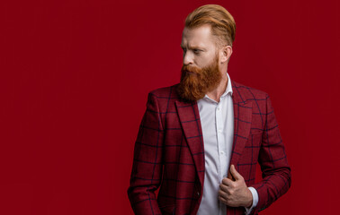 Formalwear. Tux man in formalwear isolated on red. Redhead man in formalwear tuxedo. Man wear...