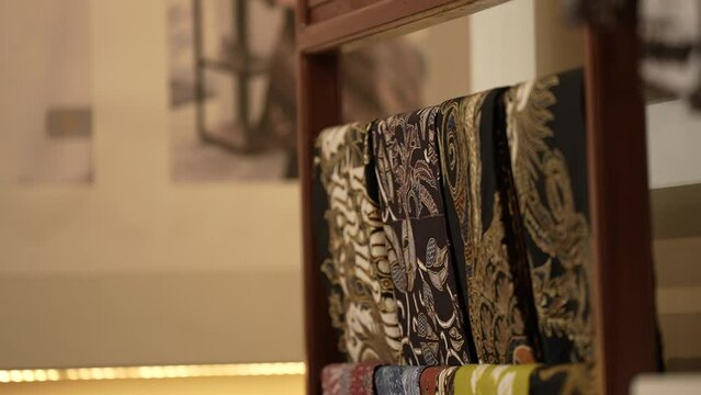 Batik cloth hanging on a rack. Clothes rack full of batik cloth. Clothes rack full of cloth