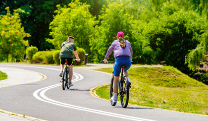 Cyclists ride on the bike path in the city Park
