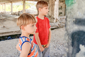Poor and dirty street children living on an abandoned constructi