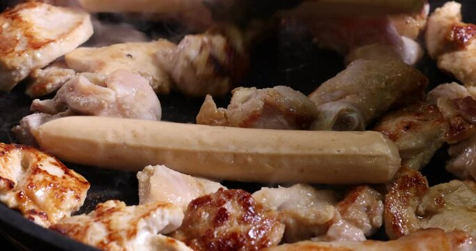 Frying skinless small chicken fillet pieces sausage bangers in lightly coated oil thyme herb non stick pan cooking sizzling dark golden brown putting taking serving rolling stir