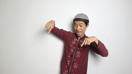 shocked asian muslim man gesturing pointing down