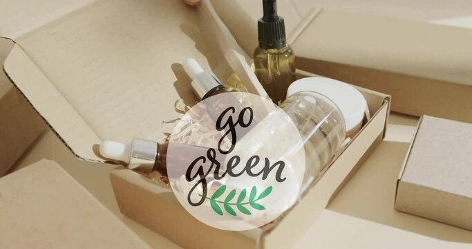 Animation of go green text and leaf logo over organic beauty products in plain packaging