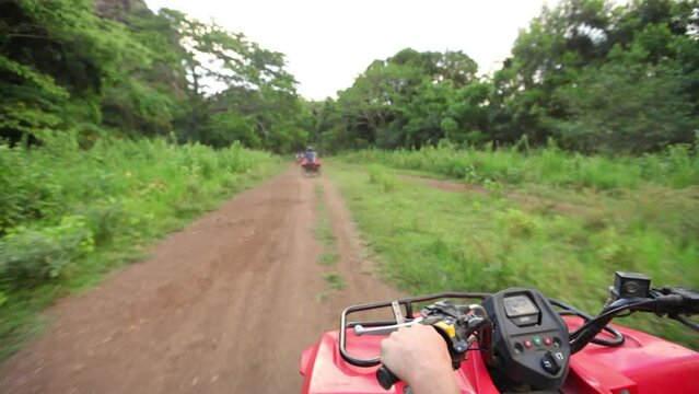 Riding 4-wheeler on dirt road in Hawaii