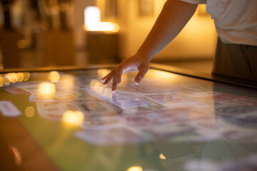 Education, entertainment, learning, technology concept - woman using interactive touchscreen...