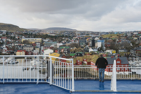 Panoramic scenic coastal view over Thorshavn, Faroe Island city skyline and other rocky isles with lush green meadows Danish  territory in Atlantic Ocean seen from cruiseship cruise ship liner